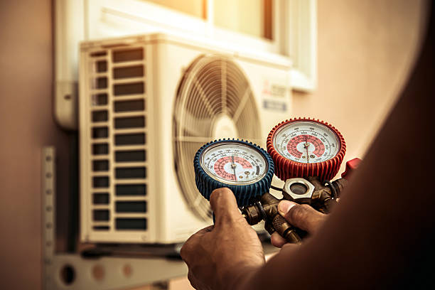 Professional Air Conditioning Service technician working in Watkins, CO